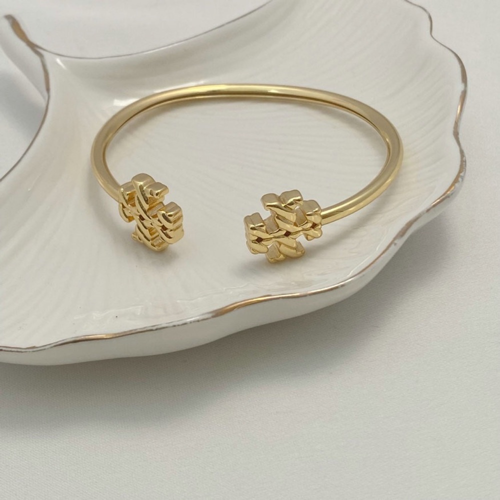 Tory Burch Elegant Gold Bracelet with Designer Charm